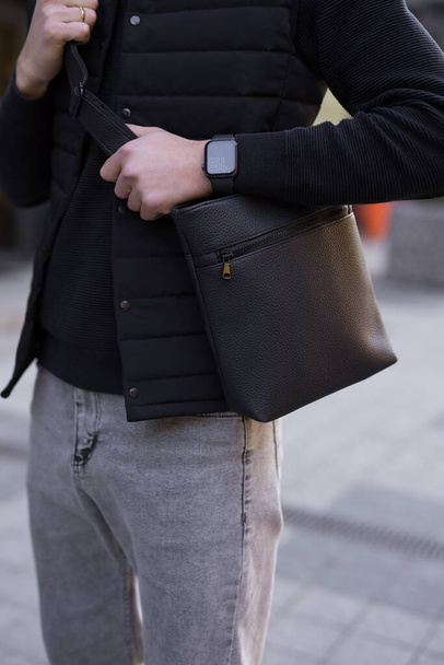 Closeup unrecognizable man holding messenger bag in a city - Φωτογραφία, εικόνα