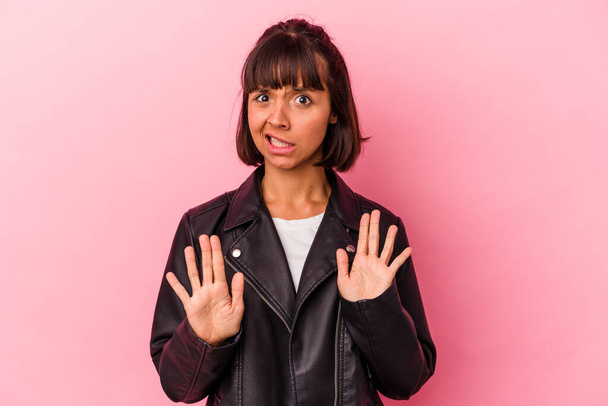 Young mixed race woman isolated on pink background rejecting someone showing a gesture of disgust. - Photo, Image