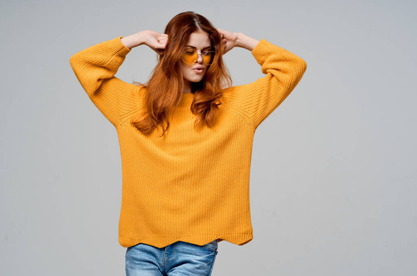 pretty woman in a yellow sweater fashion glasses studio model - Zdjęcie, obraz