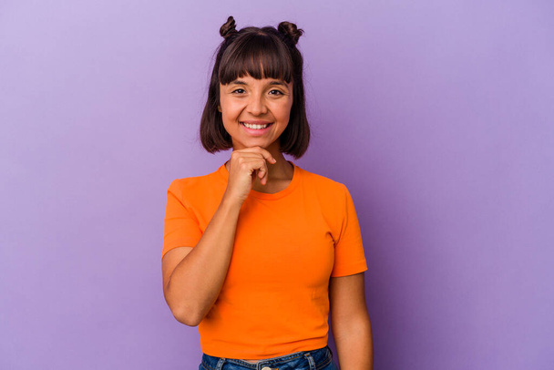Young mixed race woman isolated on purple background smiling happy and confident, touching chin with hand. - Photo, Image