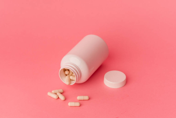 Pills isolated on pink background - Фото, изображение