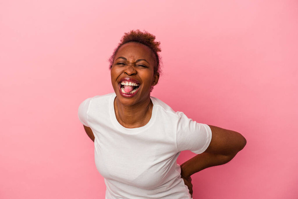 Young african american woman isolated on pink background funny and friendly sticking out tongue. - Photo, Image
