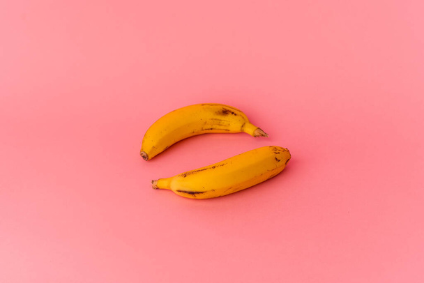 Two bananas isolated on pink background - Zdjęcie, obraz