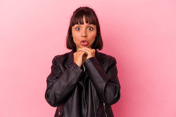 Young mixed race woman isolated on pink background praying for luck, amazed and opening mouth looking to front. - Photo, image