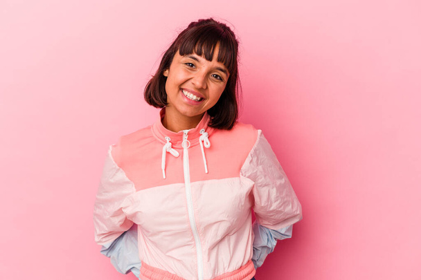 Young mixed race woman isolated on pink background happy, smiling and cheerful. - 写真・画像