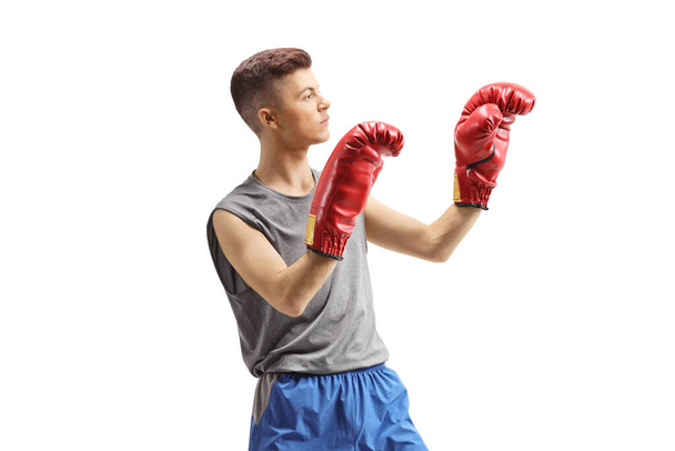 Guy exercising with boxing gloves isolated on white background - Фото, изображение