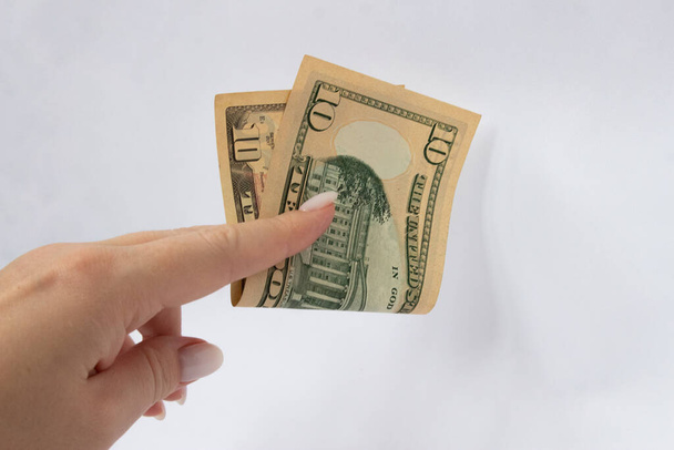 10 dollars in the hand close-up on a white isolated background. A ten-dollar bill - Foto, immagini