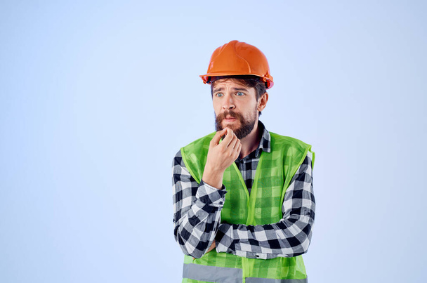 Turuncu başlıklı sakallı adam inşaat alanında profesyonel mavi arka plan - Fotoğraf, Görsel