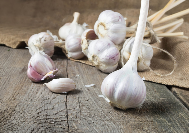 Raw fresh garlic in wooden background  - Photo, Image