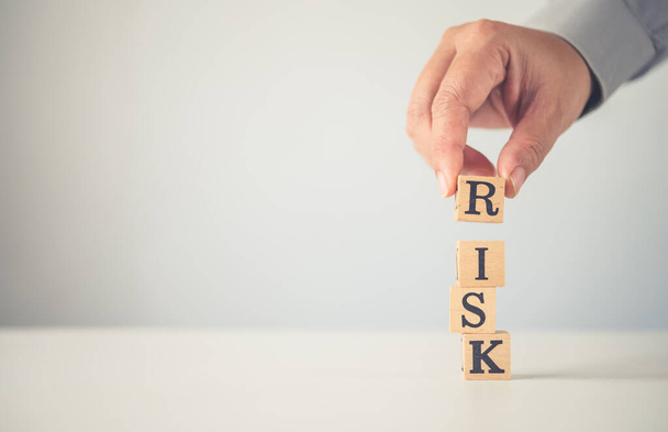 Hand hold wooden block with the word "RISK". Concept risk - Foto, Imagen