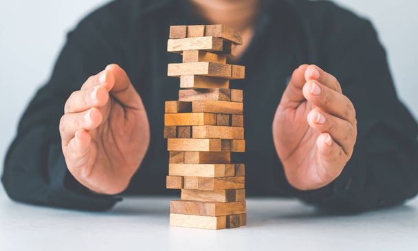 Business risks in the business. Requires planning Meditation must be careful in deciding to reduce the risk in the business. As the game drew to a wooden block from the tower - Photo, Image