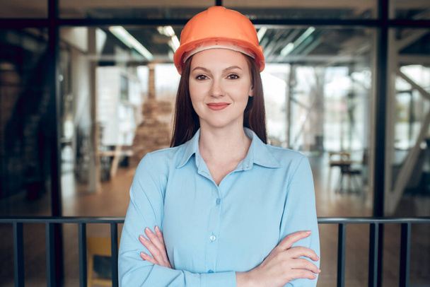 Optimistic young woman in safety helmet - Foto, immagini