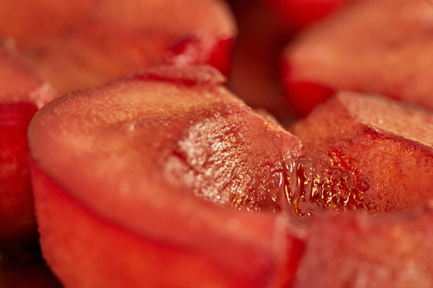Ready-made pears cooked in red syrup with wine close-up. Macro - Photo, Image