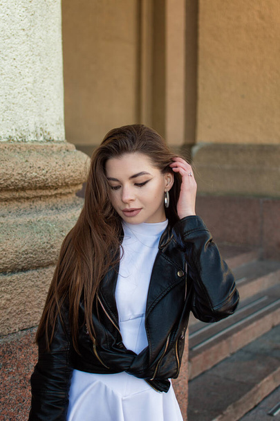 Pretty stylish girl. Young woman in black leather coat - Zdjęcie, obraz