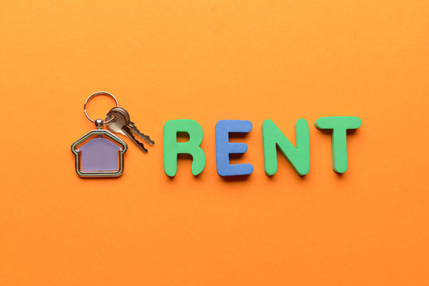 Key from house and word RENT on orange background - Photo, Image