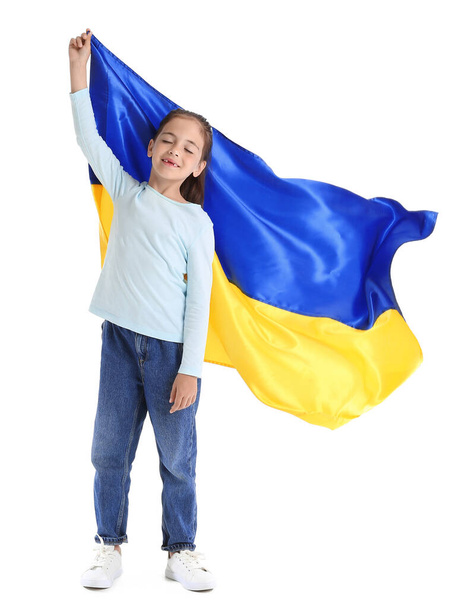 Little girl with Ukrainian flag on white background - Valokuva, kuva