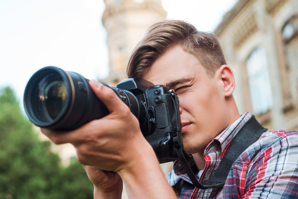 Man taking  photograph with digital camera - Foto, Bild
