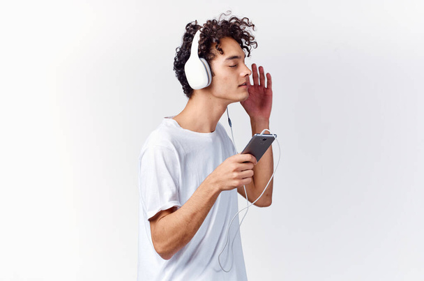 guy in white t-shirt with headphones music lifestyle - Фото, изображение