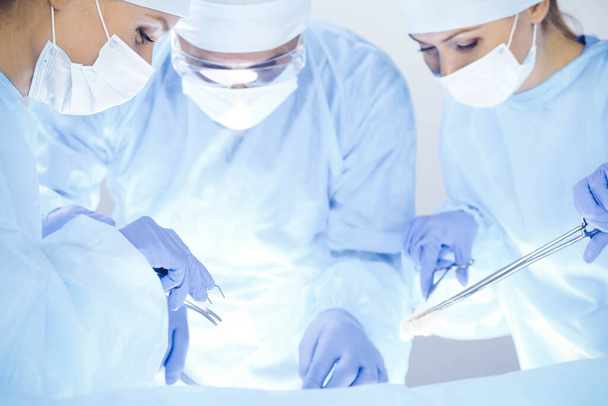 A group of surgeons is operating at the hospital. Health care concept - Fotoğraf, Görsel