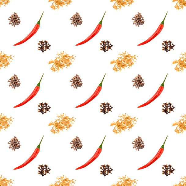 Seamless spice pattern with red chili pepper pods, heaps of cloves, fenugreek, allspice on white background. Delicious food concept - 写真・画像