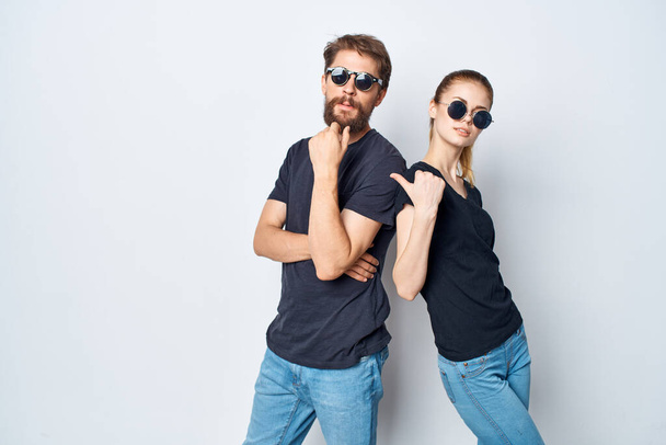 fashionable man and woman friendship communication romance wearing sunglasses light background - Foto, afbeelding