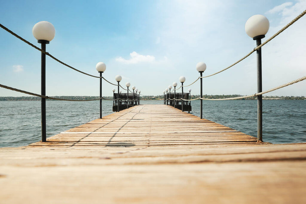 Beautiful river scene with wooden pier on sunny day - Fotoğraf, Görsel