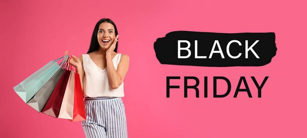 Black Friday Sale. Beautiful young woman with shopping bags on pink background, banner design - Photo, Image