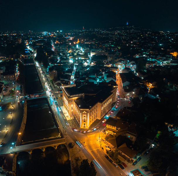 Akşam Saraybosna şehir merkezi, belediye binası ve Miljacka nehrinin insansız hava aracı görüntüsü - Fotoğraf, Görsel