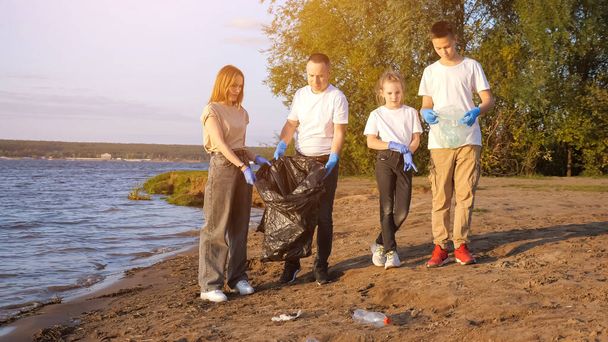Familie sorteert afval aan de kust - Foto, afbeelding