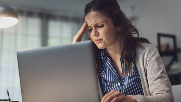 Stressed office worker having a headache, job burnout concept - Photo, Image