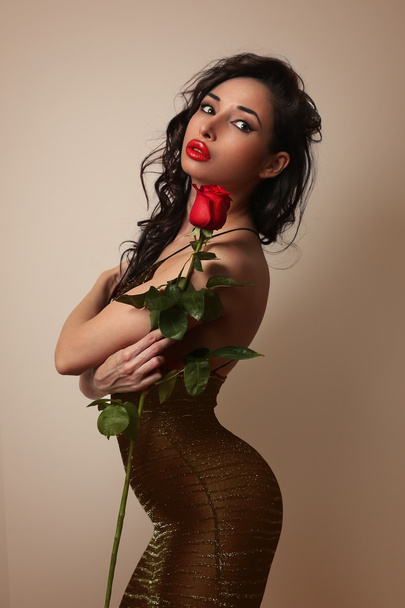 Sexy girl in little black dress with a red rose - Фото, изображение