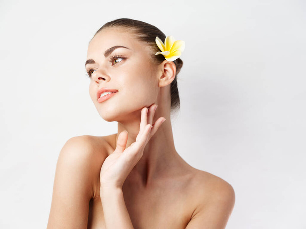 woman naked shoulders attractive look yellow flower in hair - Photo, Image