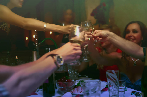 people hands toasting  glasses at party table. - Fotó, kép