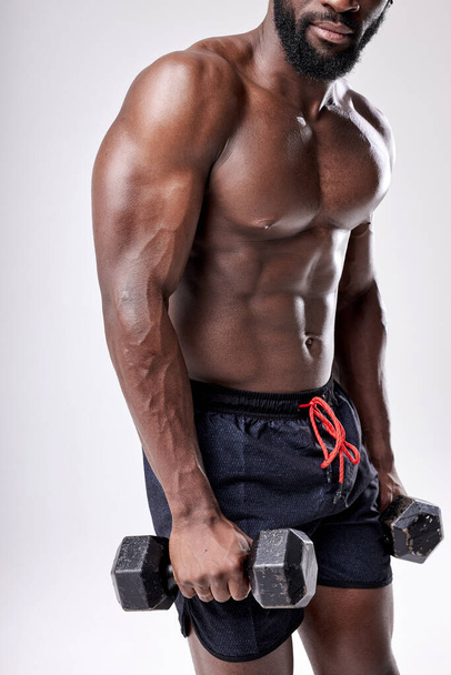 Cropped Muscular African Man With Naked Torso Holding Dumbbells In Hands, Exercising - Foto, immagini