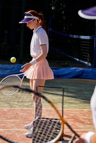 Confident tennis player playing game on outdoor court. Athlete caucasian woman with racket - Zdjęcie, obraz