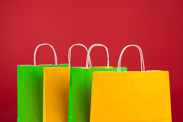 Arrangement of shopping bags on red background - Foto, Imagen