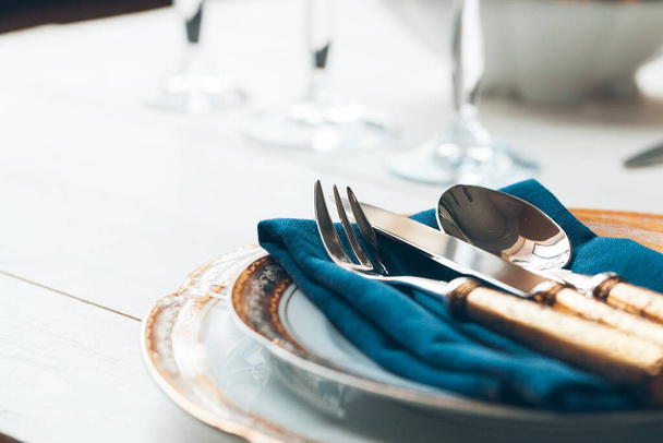Close up shot of table setting for fine dining with cutlery and glassware - Foto, Imagem
