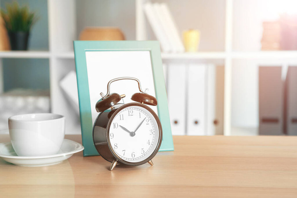 Office interior details with alarm clock and stationery items - Photo, image