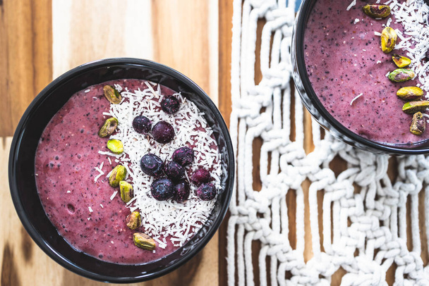 vegan acai blueberries coconut smoothie bowl, healthy plant-based food recipes - Фото, изображение