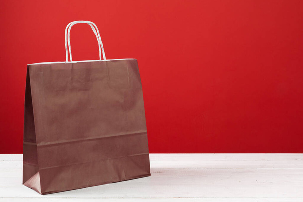 Paper shopping bags with copy space on red background - Foto, Bild