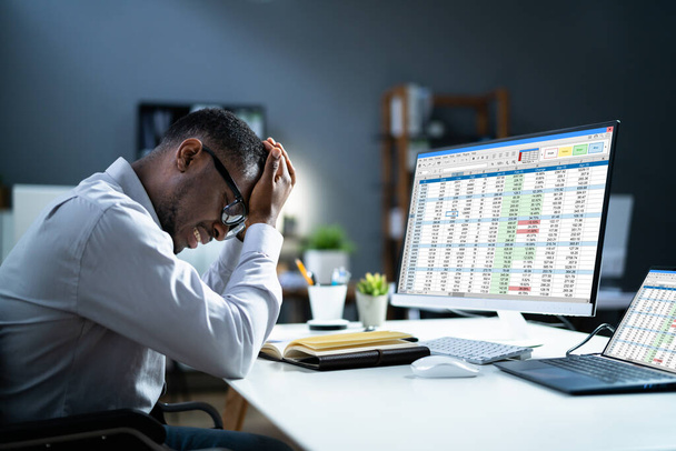 Stressed Depressed African Man At Desk. Tired Bored Businessman - Foto, afbeelding