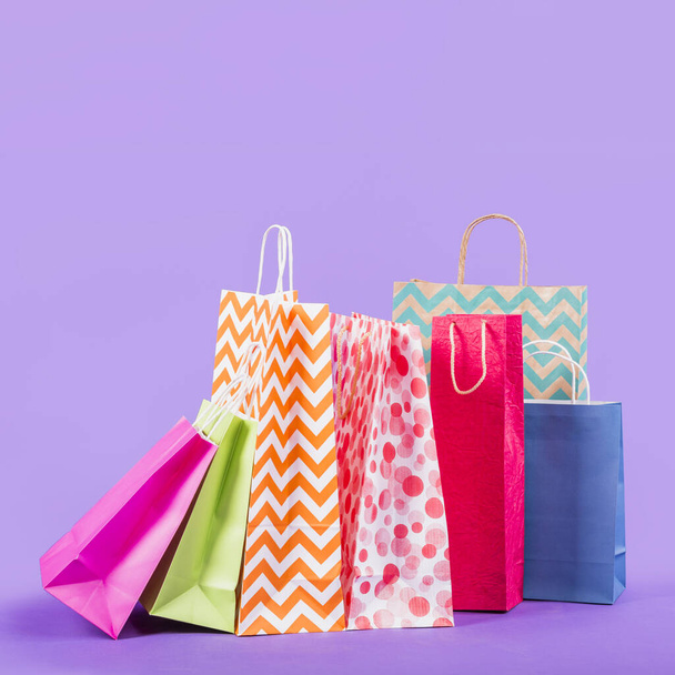 colorful empty shopping bags purple background. High quality beautiful photo concept - Foto, Imagen