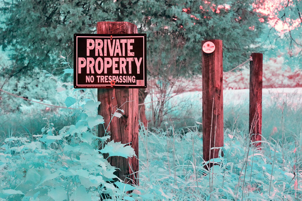 Private Property sign in a teal forest all shot in infrared - Photo, Image