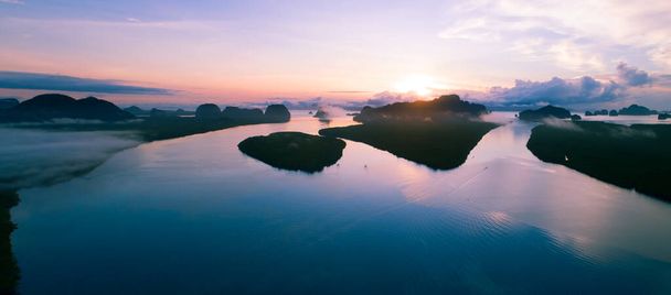 Aerial view drone Panorama of beautiful ocean against sky in the morning fog mist sunrise drone is flying over sea and mangrove forest Landscape High angle view Dynamic aerial shot Amazing nature view - Photo, Image