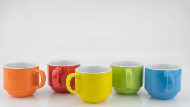 Colorful coffee cup on colorful paper background A lot of cups for coffee and tea in coffee shop Food and drink background concept - Photo, Image