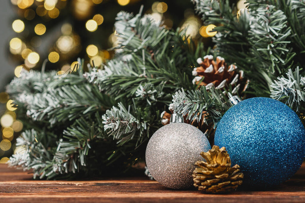 Christmas decorative balls against blurred pine tree background - Foto, imagen