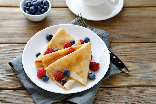 summer crepes with berries on white plates - Fotoğraf, Görsel