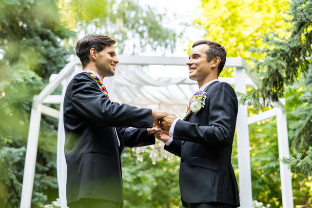 Homosexual couple celebrating their own wedding - LBGT couple at wedding ceremony, concepts about inclusiveness, LGBTQ community and social equity - Foto, afbeelding