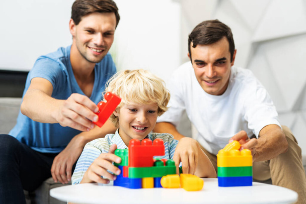 Lgbt family, gay couple with adopted son - Homosexual parents with their kid having fun at home - Foto, afbeelding