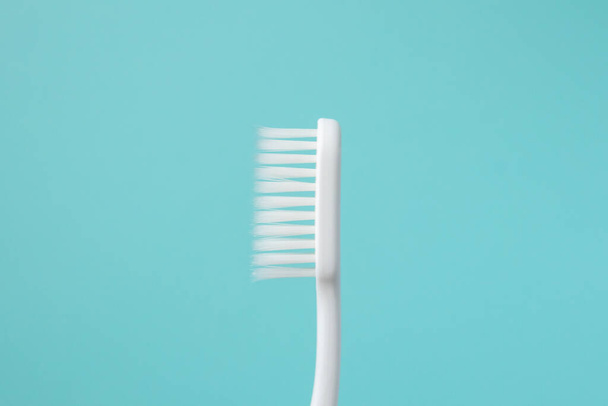 Toothbrush on blue background top view close up - Фото, зображення